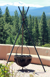 hanging mesh cauldron fire pit filled with lava rock